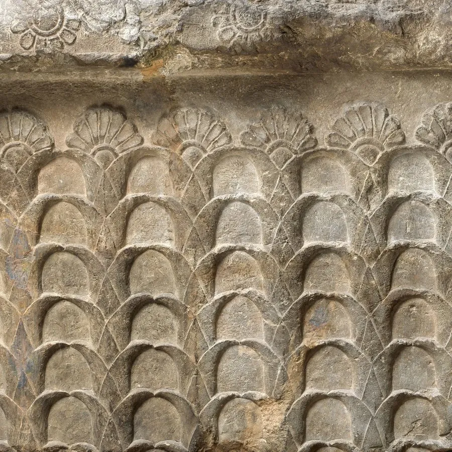 Relief of lotus flower design carved into stone.